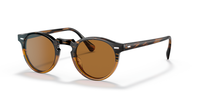 A pair of Oliver Peoples sunglasses with brown lenses and metal frame.