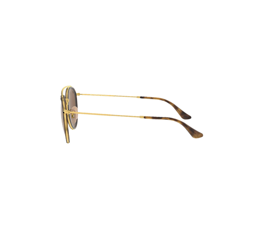 A pair of Rayban sunglasses with gold-colored frames, viewed from the side.