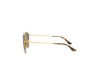 A pair of Rayban sunglasses with gold-colored frames, viewed from the side.