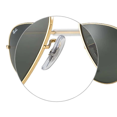 Close-up view of Ray-Ban sunglasses showcasing the replacement nose pads and the brand's logo on the side.
