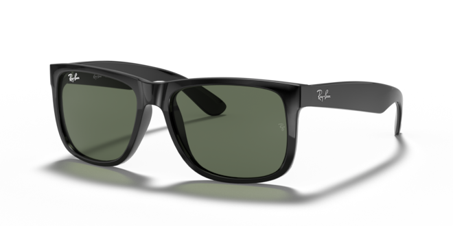 Black sunglasses with green lenses on a white background